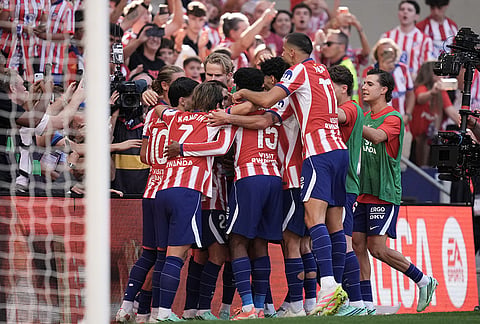 Atletico Madrid players celebrate after Alejandro Grimaldo scored the opening goal from the penalty spot during a Spanish La Liga soccer match between Atletico Madrid and Real Madrid in Madrid, Sunday, Sept. 20, 2026. 
