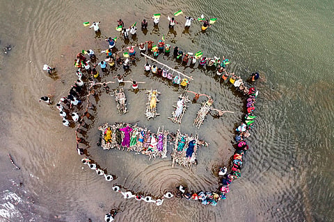 Displaced villagers affected by the 'Ken-Betwa', 'Majhgawan', and 'Runjh' river interlinking projects stage a symbolic 'Chita Andolan' protest on funeral pyres to demand compensation and rehabilitation following home submersions, in Panna, Madhya Pradesh, Sunday, Sept. 20, 2026.