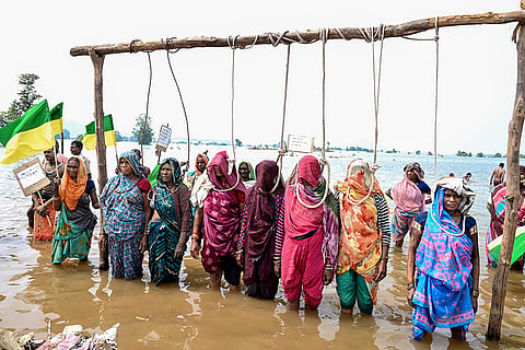 Displaced villagers affected by the 'Ken-Betwa', 'Majhgawan', and 'Runjh' river interlinking projects stage a symbolic 'Chita Andolan' protest on funeral pyres to demand compensation and rehabilitation following home submersions, in Panna, Madhya Pradesh, Sunday, Sept. 20, 2026.