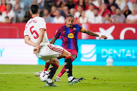 Barcelona's Raphinha, right, scores his side's first goal the Spanish La Liga soccer match between Sevilla and Barcelona in Seville, Spain.