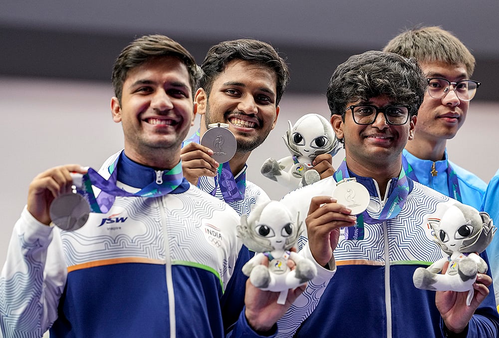 India’s Himanshu Dhillon, left, Rudrankksh Patil, Parth Rakesh Mane, right, and others pose for photographs after wiining silver medal in the 10 meter rifle men team event in the ongoing 20th Asian Games 2026, in Nagoya, Japan, Monday, Sept. 21, 2026.  - | Photo: PTI/Atul Yadav