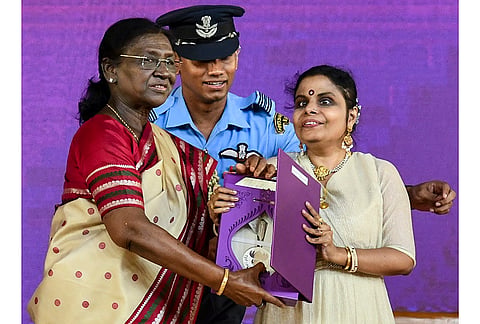 President Droupadi Murmu confers award for Best Female Playback Singer on singer Vaikom Vijayalakshmi for her rendition of 'Angu Vaana Konilu' from the Malayalam film 'A. R. M.' during the 72nd National Film Awards, at Kevadia, in Narmada district, Gujarat. 
