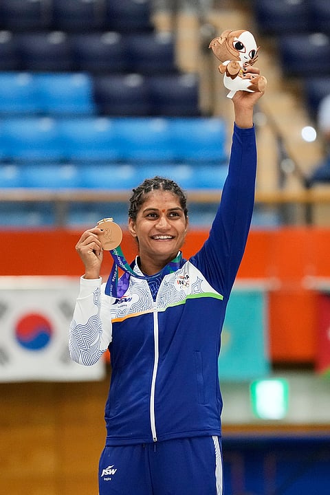 Bronze medalist Suchika Tariyal of India poses on the podium during the medal ceremony for the women's traditional 60 kg mixed martial arts at the Asian Games in Nagoya, Japan, Tuesday, Sept. 22, 2026. 