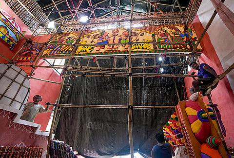 Workers prepare installations for a community 'pandal' as preparations are underway ahead of Durga Puja festival, in Kolkata, West Bengal, Tuesday, Sept. 22, 2026. 
