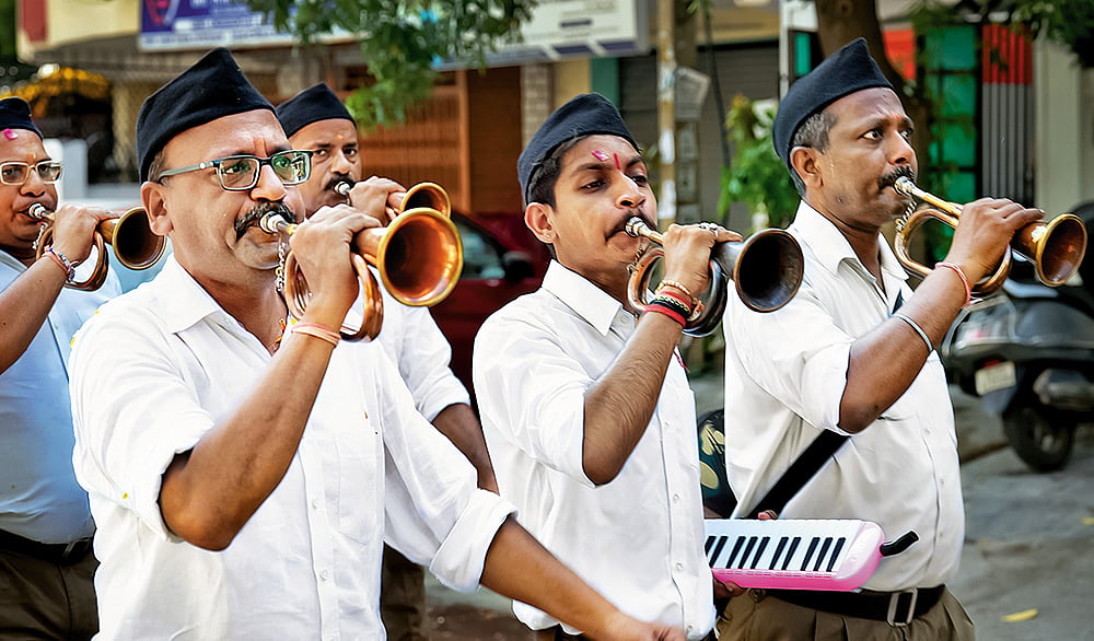 Members of the RSS participate in a march in 2025