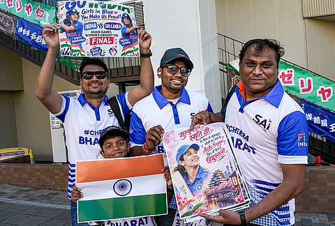 Indian-origin residents living in Japan pose for photographs as they head to watch the women’s cricket match final of the Asian Games 2026 between India and Sri Lanka, in Nagoya, Japan.