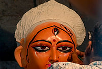 In Photos: Kolkata Prepares To Welcome Goddess Durga | Photo: PTI : An artist paints on an idol of Goddess Durga ahead of the 'Durga Puja' festival, in Kolkata, Monday, Sept. 21, 2026.