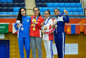 | Photo: AP/Dita Alangkara : Medalists from left, Sobirova Khiola of Uzbekistan, silver, Teo Hui Hoon, of Singapore, gold, Daalin Cheng of Cambodia and Suchika Tariyal of India, bronze, pose on the podium during the medal ceremony for the women's traditional 60 kg mixed martial arts at the Asian Games in Nagoya, Japan, Tuesday, Sept. 22, 2026.