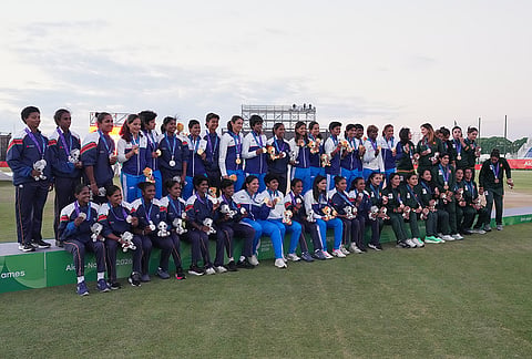 Gold medalist team India, in blue and white, silver medalist team Sri Lanka, in dark blue, and bronze medalist team Pakistan, in green, pose on the podium after the women's gold medal T20 cricket game between India and Sri Lanka at the Asian Games in Nisshin, Japan, Tuesday, Sept. 22, 2026.