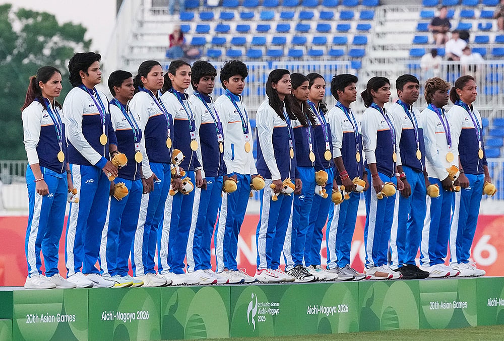 Gold Medalist team India stands for their national anthem on the podium after beating team Sri Lanka in the women's gold medal T20 cricket game at the Asian Games in Nisshin, Japan, Tuesday, Sept. 22, 2026.  - | Photo: AP/Mark Baker