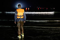 | Photo: AP/Jean-Francois Badias : A man stands on the beach as he tries to cross the channel from France to Britain on a dinghy boat, in Hardelot, northern France, Wednesday, Sept. 23, 2026. 
