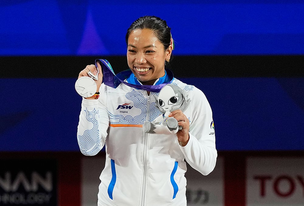 Silver medalist Mirabai Chanu Saikhom of India poses on the podium after the women's 49kg weightlifting final at the Asian Games in Nagoya, Japan, Wednesday, Sept. 23, 2026.  - | Photo: AP/Dita Alangkara