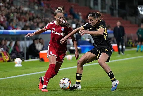 Bayern's Giulia Gwinn, left, tries to dribble the ball past Manchester City's Carlotta Wamser during the women's Champions League opening phase soccer match between FC Bayern Munich and Manchester City in Munich, Germany, Tuesday, Sept. 22, 2026. 