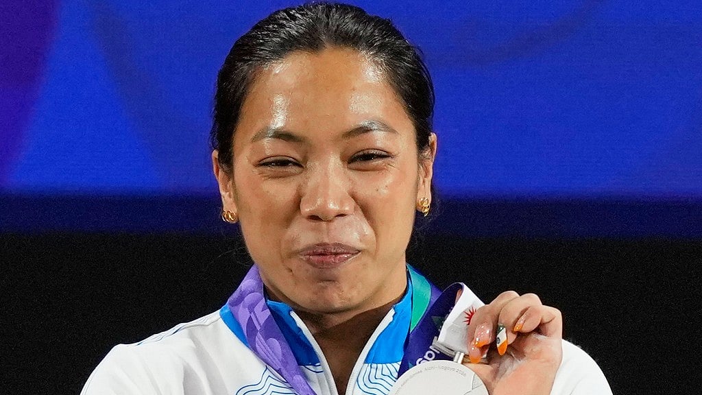 Silver medalist Mirabai Chanu Saikhom of India poses on the podium after the women's 49kg weightlifting final at the Asian Games in Nagoya, Japan. - Dita Alangkara/AP Photo