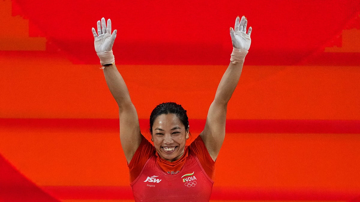 Mirabai Chanu Saikhom of India celebrates after her successful lift as she competes during the women's 49kg weightlifting final at the Asian Games in Nagoya, Japan, Wednesday, Sept. 23, 2026. - (AP Photo/Dita Alangkara)