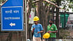 | Photo: PTI/Karma Bhutia : Construction workers walk past a signboard of Shastri Bhawan after the Central Public Works Department (CPWD) initiated the process to vacate the building by the end of September 