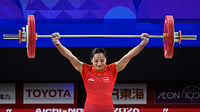 (AP Photo/Dita Alangkara) : Mirabai Chanu Saikhom of India competes during the women's 49kg weightlifting final at the Asian Games in Nagoya, Japan, Wednesday, Sept. 23, 2026.