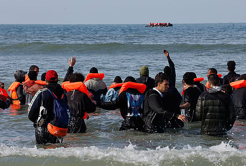 A group of migrants wait to cross the English channel, from France to Britain, on a dinghy, in Hardelot, northern France, Wednesday Sept. 23, 2026. 