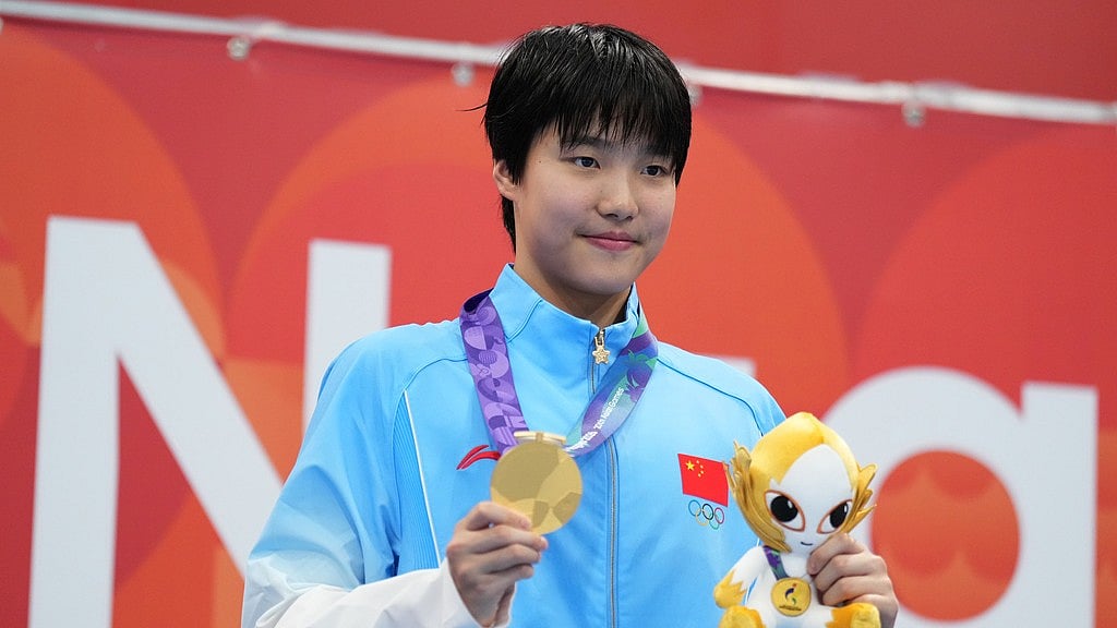 Gold medalist Yu Zidi of China poses on the podium after the women's 200-meter individual medley final in swimming at the Asian Games in Tokyo. - Hiro Komae/AP Photo