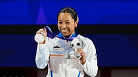 (AP Photo/Dita Alangkara) : Silver medalist Mirabai Chanu Saikhom of India poses on the podium after the women's 49kg weightlifting final at the Asian Games in Nagoya, Japan, Wednesday, Sept. 23, 2026.