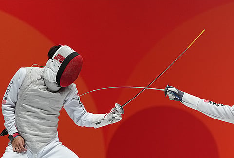 Kyosuke Matsuyama of Japan, left, competes against Kazuki Iimura of Japan during a men's foil individual fencing semi-final at the Asian Games in Nagoya, Japan.