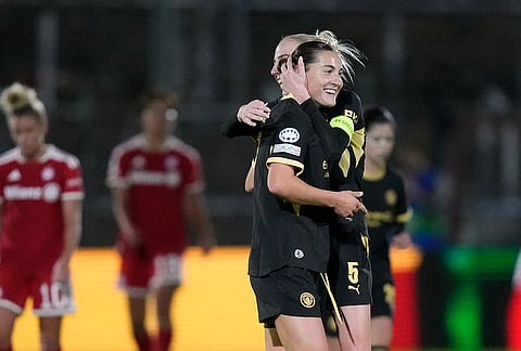 Manchester City's Carlotta Wamser celebrates with Alex Greenwood, background, after scoring her side's second goal during the women's Champions League opening phase soccer match between FC Bayern Munich and Manchester City in Munich, Germany, Tuesday, Sept. 22, 2026. 