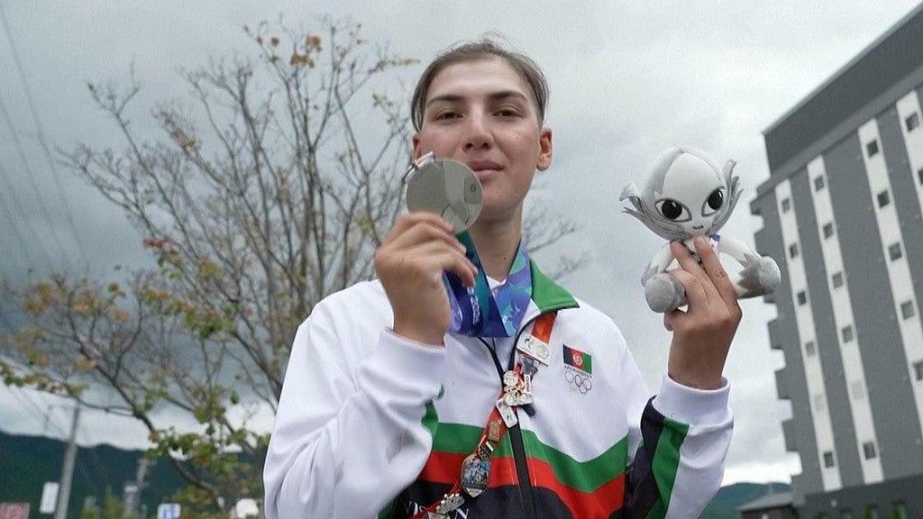 Afghanistan's Fariba Hashim displays the silver medal she won for Women's Road Race. - SNTV via AP