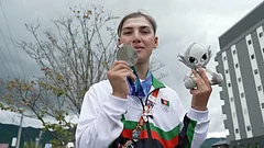 Afghanistan's Fariba Hashim displays the silver medal she won for Women's Road Race. - SNTV via AP