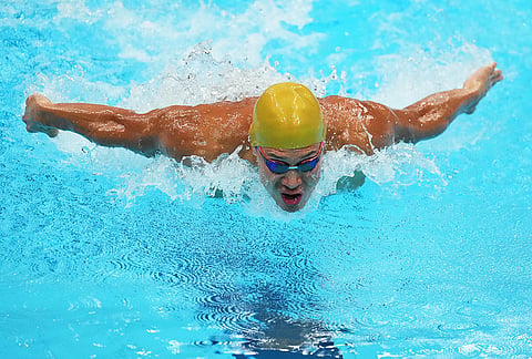Adilbek Mussin of Kazakhstan competes in the men's 100-meter butterfly heats in swimming at the Asian Games in Tokyo, Japan.