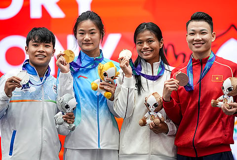 From left, India’s silver medallist Roshibina Devi Naorem, China's gold medallist Zhang Xiaoyu, and others during the medal ceremony at the 20th Asian Games, in Nagoya, Japan, Thursday, Sept. 24, 2026. 