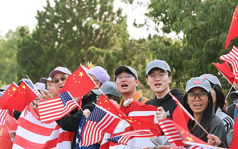 Local Chinese lined up streets and waved flags of China and the US to welcome President Xi