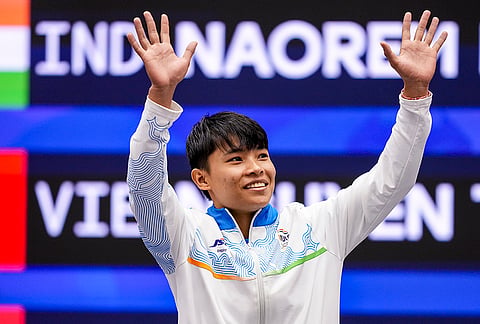 India’s Roshibina Devi Naorem gestures during the medal ceremony after the Women’s 60kg Wushu final match during the 20th Asian Games, in Nagoya, Japan, Thursday, Sept. 24, 2026. She lost to China's Zhang Xiaoyu, 0-2, and won the silver medal. 