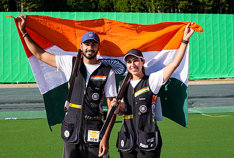 India’s Parinaaz Dhaliwal, right, and Anant Jeet Singh Naruka hold the national flag after securing the bronze medal in the Skeet Mixed Team final match during the 20th Asian Games, in Nagoya, Japan, Thursday, Sept. 24, 2026. 