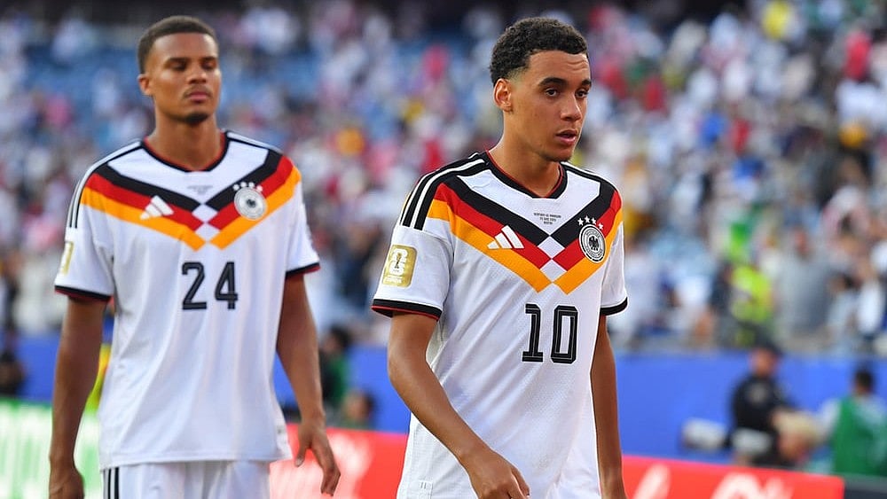 Germany's Jamal Musiala (10) and Malick Thiaw (24) walk off the field after losing to Paraguay in a shootout during the World Cup round of 32 soccer match in Foxborough, Mass., near Boston. - | Photo: AP/Steven Senne