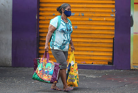 A woman wears a mask to protect herself from smoke coming from wildfires in Manaus, Amazonas state, Brazil, Wednesday, Sept. 23, 2026. 