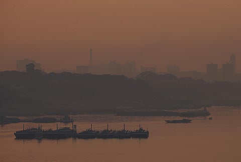 Fuel barges are seen on the Negro River, as smoke from wildfires fills the air in Manaus, Amazonas state, Brazil, Wednesday, Sept. 23, 2026. 