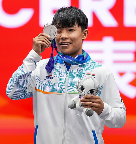 India’s Roshibina Devi Naorem shows the silver medal after the Women’s 60kg Wushu final match during the 20th Asian Games, in Nagoya, Japan, Thursday, Sept. 24, 2026. 