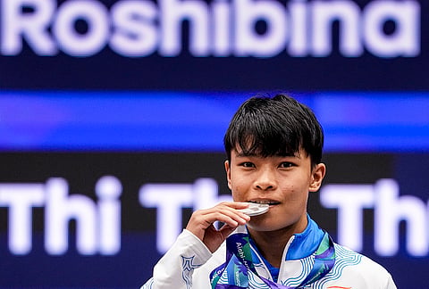 India’s Roshibina Devi Naorem holds the silver medal after the Women’s 60kg Wushu final match during the 20th Asian Games, in Nagoya, Japan, Thursday, Sept. 24, 2026. 