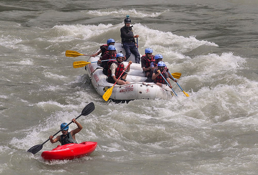 Tourists take part in river rafting