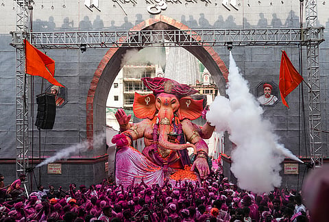 People take an idol of lord Ganesh, Raja Tejukaya, for an immersion ceremony during the conclusion of Ganesh Chaturthi festival, in Mumbai, Friday, Sept. 25, 2026. 