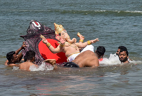 People immerse an idol of lord Ganesh in the Krishna-Koyna Sangam on the last day of 'Ganesh Chaturthi' festival, at Karad, in Satara district, Maharashtra, Friday, Sept. 25, 2026. 