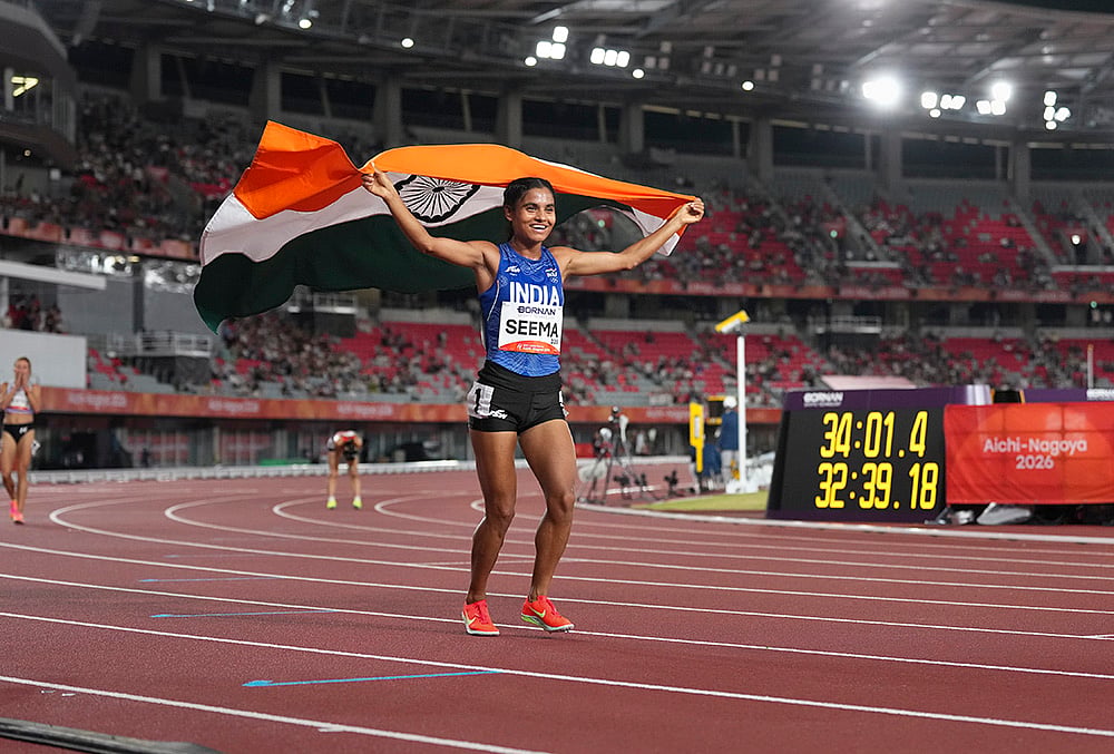 India’s Seema holds the national flag as she celebrates after winning the bronze medal in the women's 10,000m final during the Asian Games 2026, in Nagoya, Japan, Thursday, Sept. 24, 2026. - | Photo: PTI/Arun Sharma