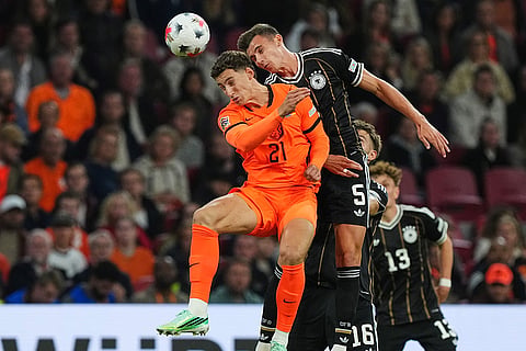 Germany's Yannik Engelhardt and Netherlands Ruben van Bommel fight for the ball during the UEFA Nations League soccer match between the Netherlands and Germany in Amsterdam, Netherlands.