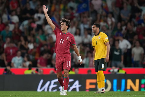 Portugal's Joao Felix, left, celebrates after scoring the opening goal during the Nations League soccer match between Portugal and Wales in Lisbon.