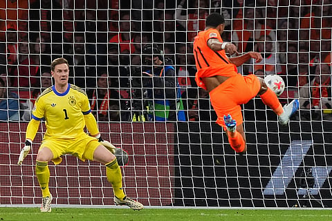 Cody Gakpo, of the Netherlands, scores during the UEFA Nations League soccer match between the Netherlands and Germany in Amsterdam, Netherlands.