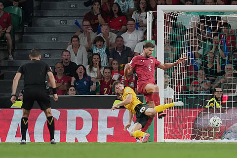 Wales' Daniel James attempts to shoot at goal as Portugal's Ruben Dias defends during the Nations League soccer match between Portugal and Wales in Lisbon.