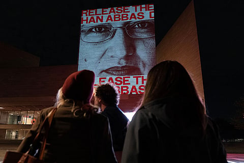 Demonstrators protest as they project faces of jailed activists during a protest against China's President Xi Jinping outside of the National Gallery of Art building Wednesday, Sept. 23, 2026, in Washington.