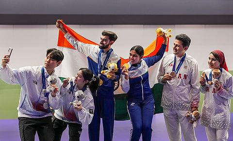 India’s Suruchi Singh and Kamaljeet, centre, Korea's Hong Suhyeon and Choo Gaeun, left, Iran'sGolkhandan Vahid and Rostamiyen Haniyeh after winning Gold, Silver and Bronze medal respectively in the 10 meter air pistol mixed team final in the ongoing Asian Games 2026, in Nagoya, Japan, Friday, Sept. 25, 2026. 