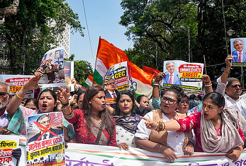 Congress workers hold placards and banners as they stage a protest against Chief Election Commissioner (CEC) Gyanesh Kumar, demanding his resignation and immediate arrest, in Kolkata, Friday, Sept. 25, 2026. 