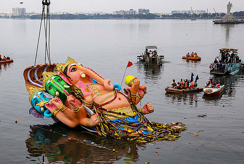 People immerse the towering ‘Panchamukha Sankatahara Maha Ganapati’ idol from Khairatabad, with the help of a crane, at Hussain Sagar Lake on the last day of the 'Ganesh Chaturthi' festival, in Hyderabad, Telangana, Friday, Sept. 25, 2026. 